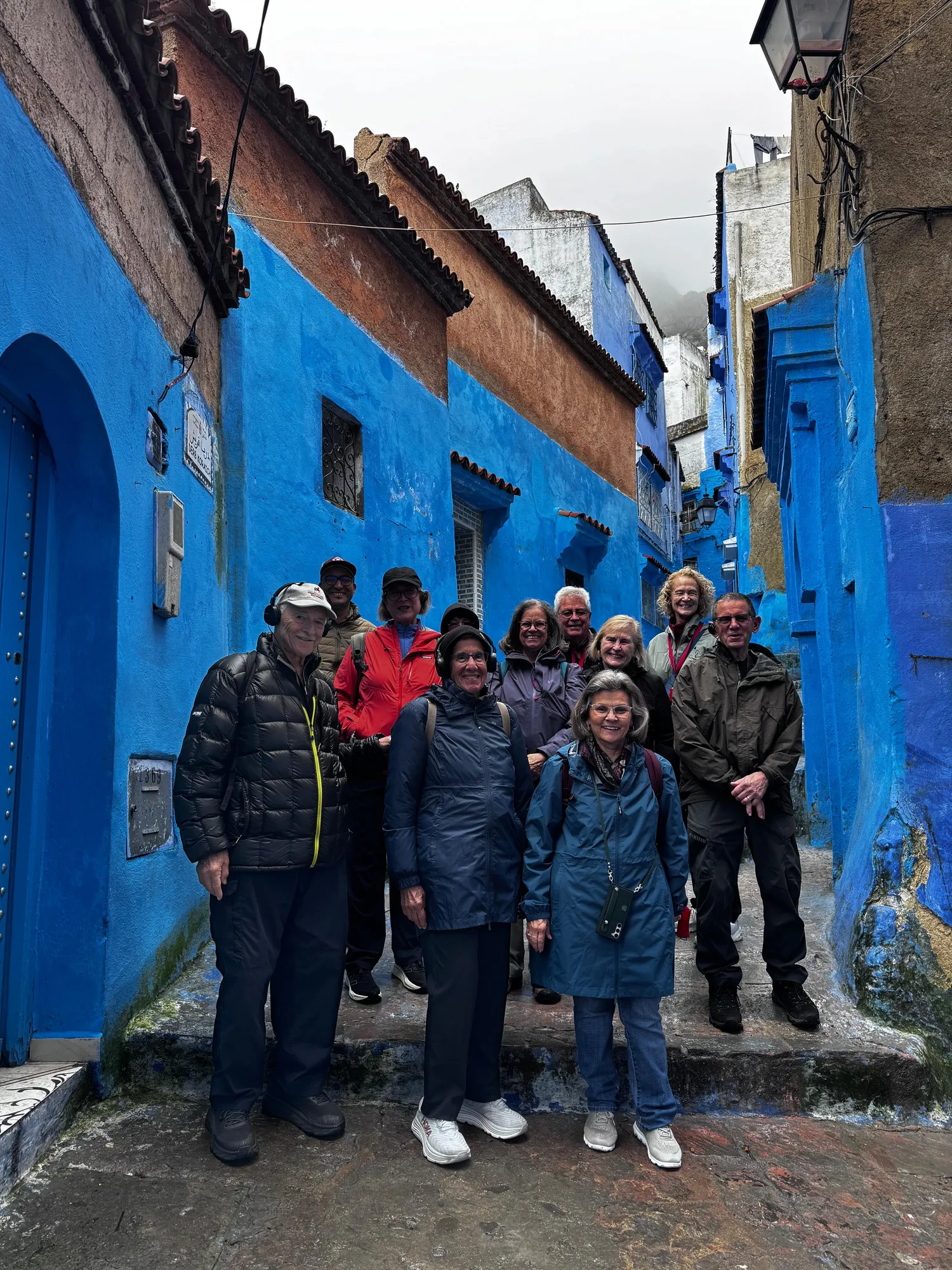 Travelers on the cobalt-blue stairways of Chefchaouen