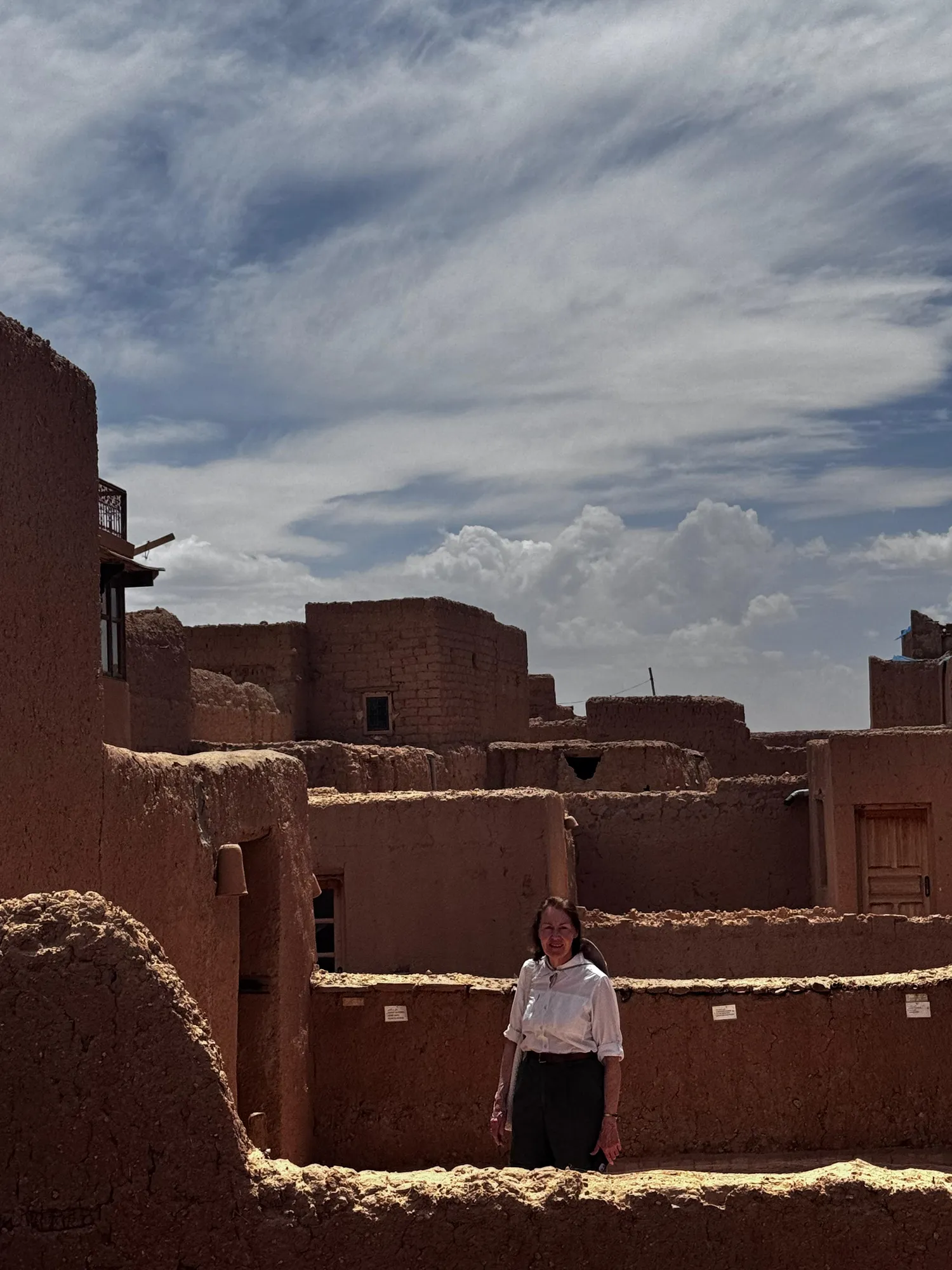 Sunlit earthen kasbah architecture along the Atlas route